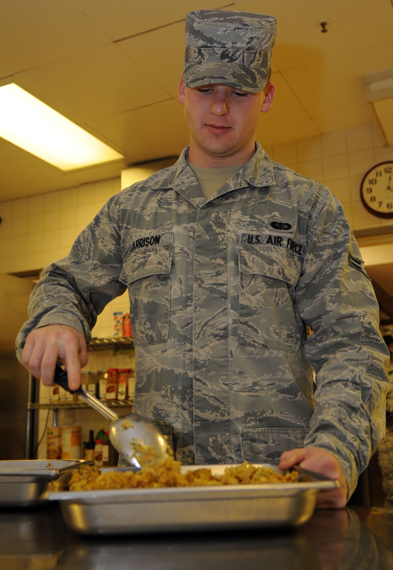Airman 1st Class Max Garrison, 100th Force Support Squadron food service journeyman, prepares stuffing for the Thanksgiving lunch served in celebration of the American holiday Nov. 22, 2012, at the Gateway Dining Facility, RAF Mildenhall, England. The 100th FSS prepared the feast to allow American service members and their families stationed in England to enjoy the holiday. (U.S. Air Force photo by Staff Sgt. Austin M. May/Released)
