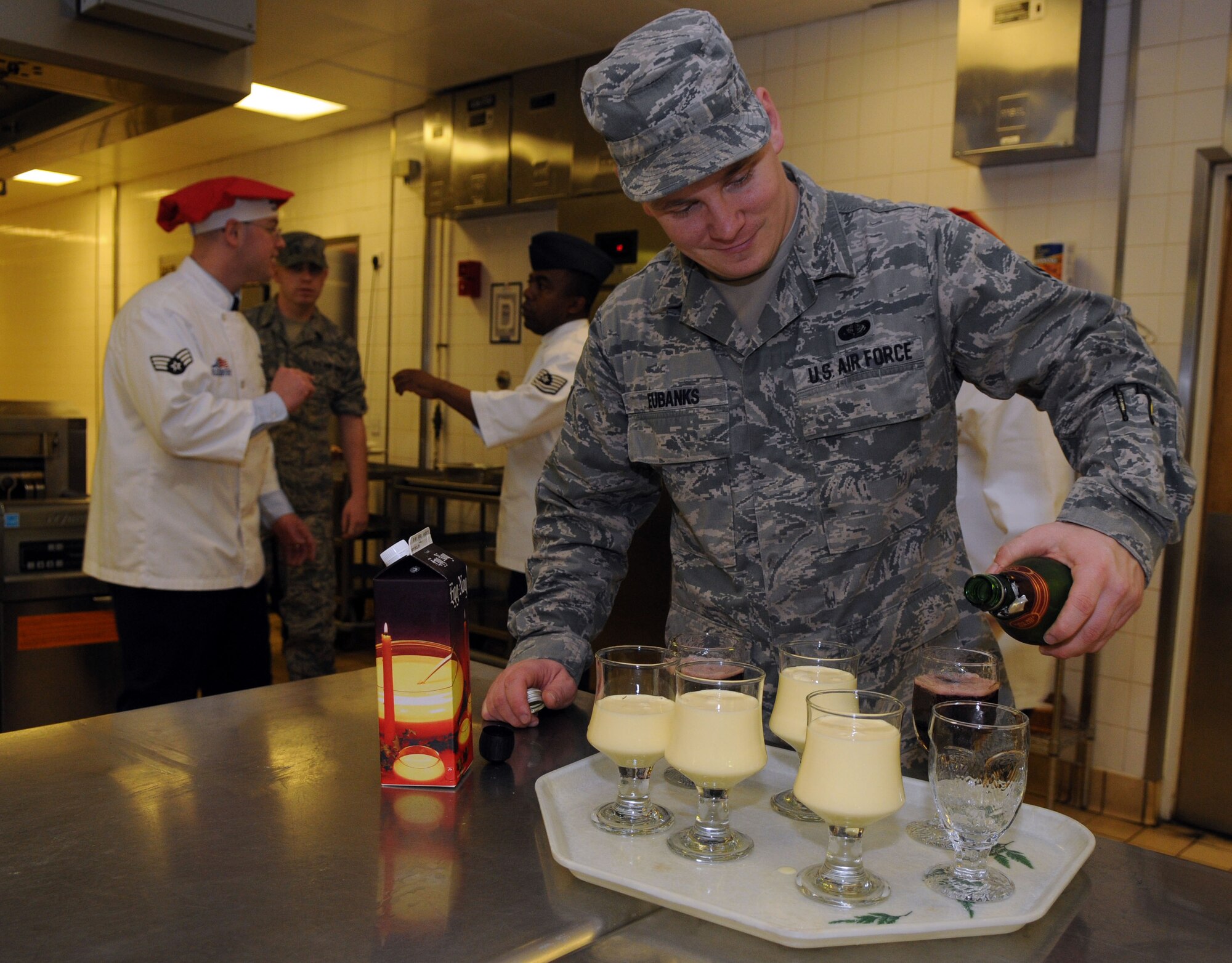 Senior Airman Michael Eubanks, 100th Force Support Squadron food service journeyman, prepares glasses of eggnog and grape juice for the Thanksgiving lunch served in celebration of the American holiday Nov. 22, 2012, at the Gateway Dining Facility, RAF Mildenhall, England. Around 350 members of Team Mildenhall attended enjoyed the feast. (U.S. Air Force photo by Staff Sgt. Austin M. May/Released)