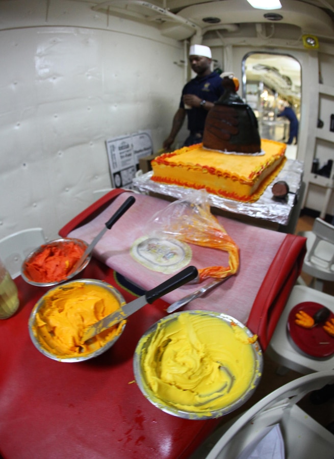 A Sailor with the Iwo Jima Amphibious Ready Group prepares frosting and decorative items for a Thanksgiving Day cake for the Marines and Sailors of the 24th Marine Expeditionary Unit and Iwo Jima ARG aboard the USS New York, Nov. 22, 2012. All three ships of the Iwo Jima ARG served Thanksgiving dinner to their crew. The 24th Marine Expeditionary Unit is currently deployed as an expeditionary crisis response force in support of maritime security operations and theater security cooperation efforts in the U.S. 6th Fleet area of responsibility. (U.S. Marine Corps photo by Cpl. Michael Petersheim)