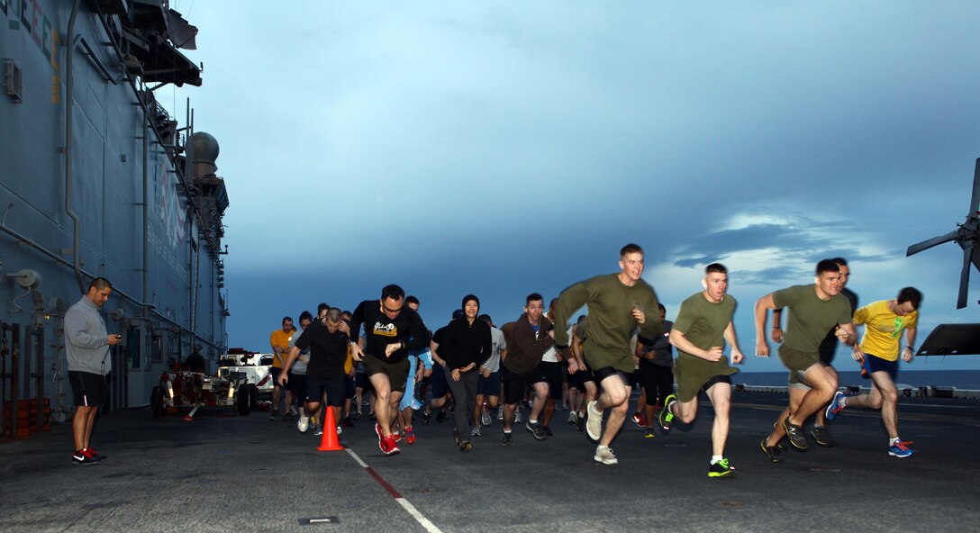 Members of the 24th Marine Expeditionary Unit and Iwo Jima Amphibious Ready Group participate in a 5K Thanksgiving fun run aboard the amphibious assault ship USS Iwo Jima, Nov. 22, 2012. The fun run is part of the Thanksgiving celebration coordinated by the ships Moral, Recreation and Welfare program for the Marines and Sailors. The 24th MEU is deployed with the Iwo Jima ARG and is currently in the 6th Fleet area of responsibility. Since deploying in March, they have supported a variety of missions in the U.S. Central, Africa and European Commands, assisted the Navy in safeguarding sea lanes, and conducted various bilateral and unilateral training events in several countries in the Middle East and Africa. (U.S. Marine Corps photo by Gunnery Sgt. Chad R. Kiehl)