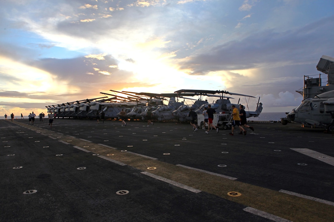 Members of the 24th Marine Expeditionary Unit and Iwo Jima Amphibious Ready Group participate in a 5K Thanksgiving fun run aboard the amphibious assault ship USS Iwo Jima, Nov. 22, 2012. The fun run is part of the Thanksgiving celebration coordinated by the ships Moral, Recreation and Welfare program for the Marines and Sailors. The 24th MEU is deployed with the Iwo Jima ARG and is currently in the 6th Fleet area of responsibility. Since deploying in March, they have supported a variety of missions in the U.S. Central, Africa and European Commands, assisted the Navy in safeguarding sea lanes, and conducted various bilateral and unilateral training events in several countries in the Middle East and Africa. (U.S. Marine Corps photo by Gunnery Sgt. Chad R. Kiehl)