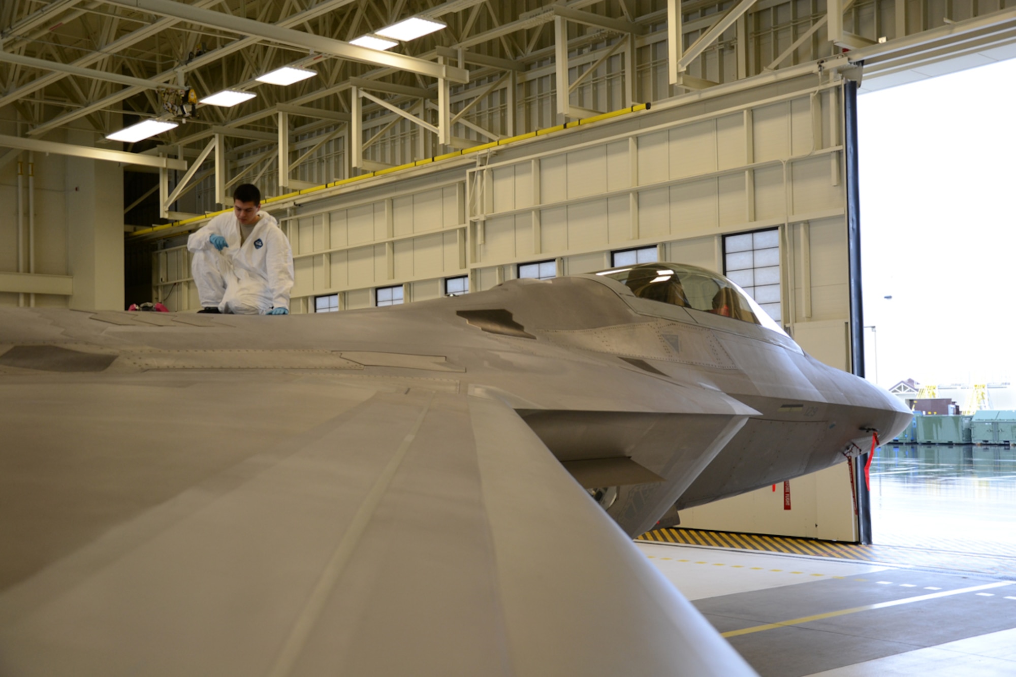 Airman 1st Class Emmanuel Marioni, 3rd Maintenance Squadron, inspects the skin of a 3rd Wing F-22 Raptor Sept. 28. Marioni is a low observable technician. (U.S. Air Force photo/Senior Airman Joan King)