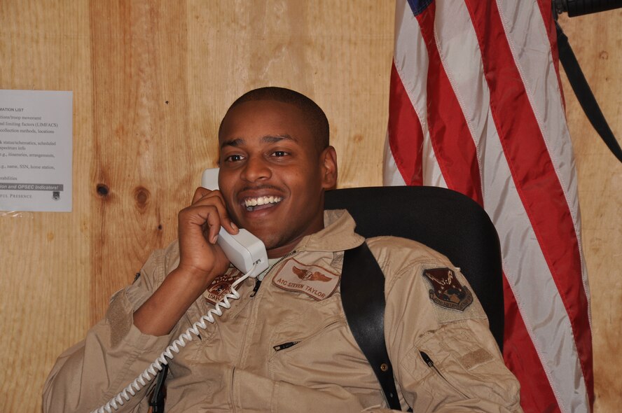 U.S. Air Force Airman 1st Class Steven Taylor, an MQ-9 Reaper sensor operator with the 62nd Expeditionary Reconnaissance Squadron at Kandahar Airfield, receives a Thanksgiving-day phone call from President Barack Obama Nov. 22. Taylor, from Sherman, Texas, said the president asked him about his family and how he was coping with his first deployment. “It’s a humbling experience more than anything, just to talk to the president as a regular person, and talk about stuff that you’re into, and your family,” he said. (U.S. Air Force Photo/Staff Sgt. Stephanie Wade) 