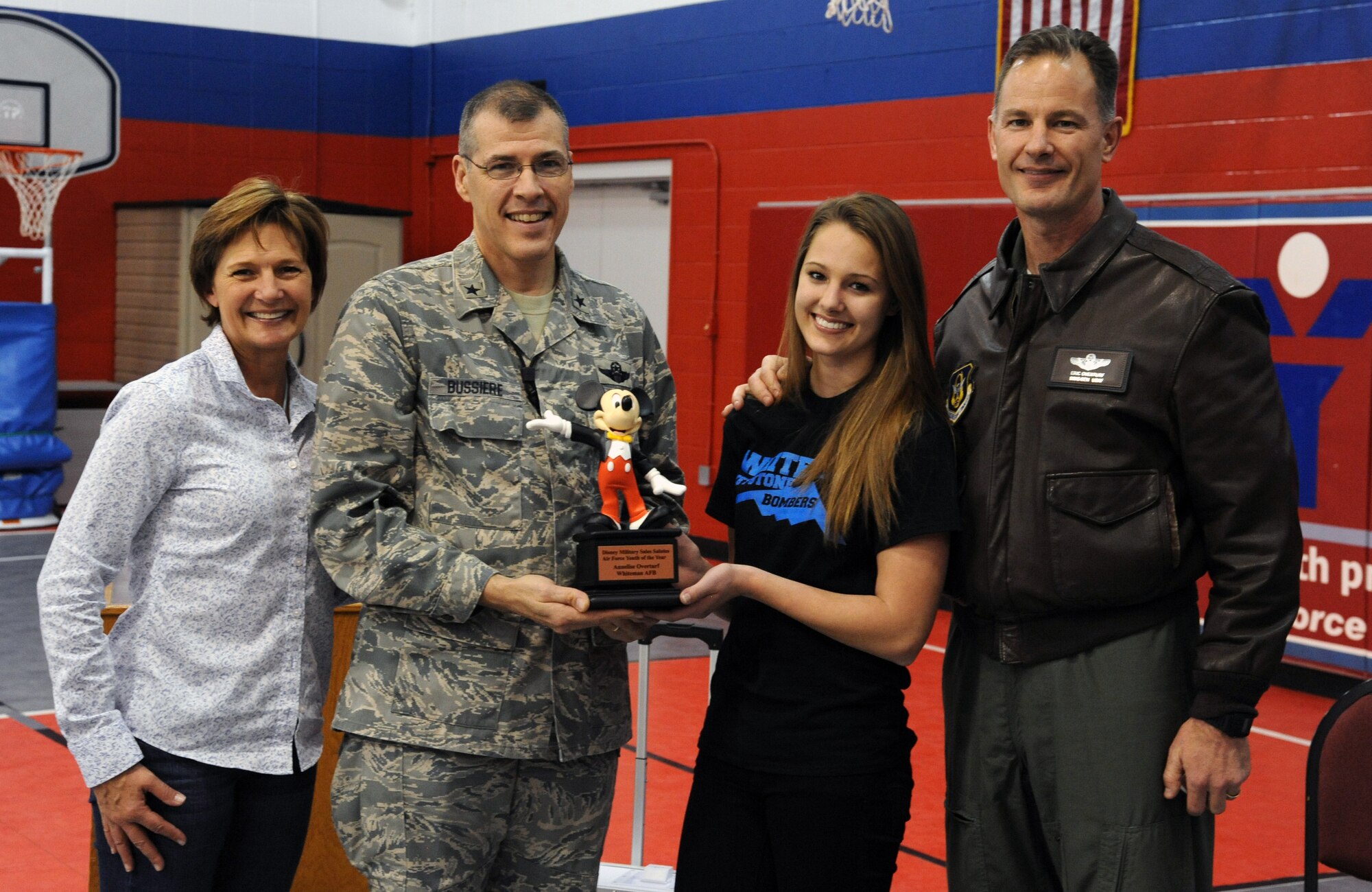 WHITEMAN AIR FORCE BASE, Mo. -- Brig. Gen. Thomas Bussiere, 509th Bomb Wing Commander, presents the Air Force Global Strike Command Youth of the Year award to Annelise Overturf, daughter of Brig. Gen. Eric Overturf, 442nd Commander, and his wife, Karla, Nov. 16 at the Youth Center. The YOY program develops teens who are articulate, well-groomed and knowledgeable into spokespersons for their teen programs and community. (U.S. Air Force photo/ Senior Airman Montse Belleau) (Released)