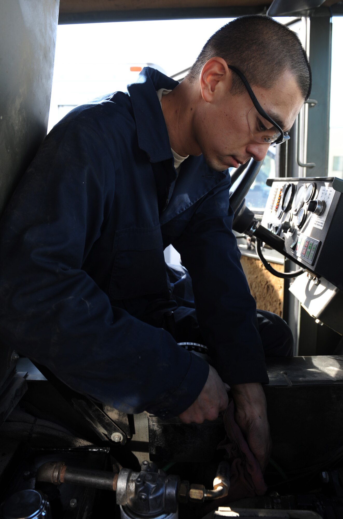 WHITEMAN AIR FORCE BASE, Mo. -- Staff Sgt. Clayton Min, 509th Logistics Readiness Squadron vehicle mechanic, checks the oil during a routine vehicle inspection, Nov. 2. The vehicle maintenance shop performs basic scheduled maintenance for all vehicles on base. (U.S. Air Force photo/Airman 1st Class Bryan Crane) (Released)