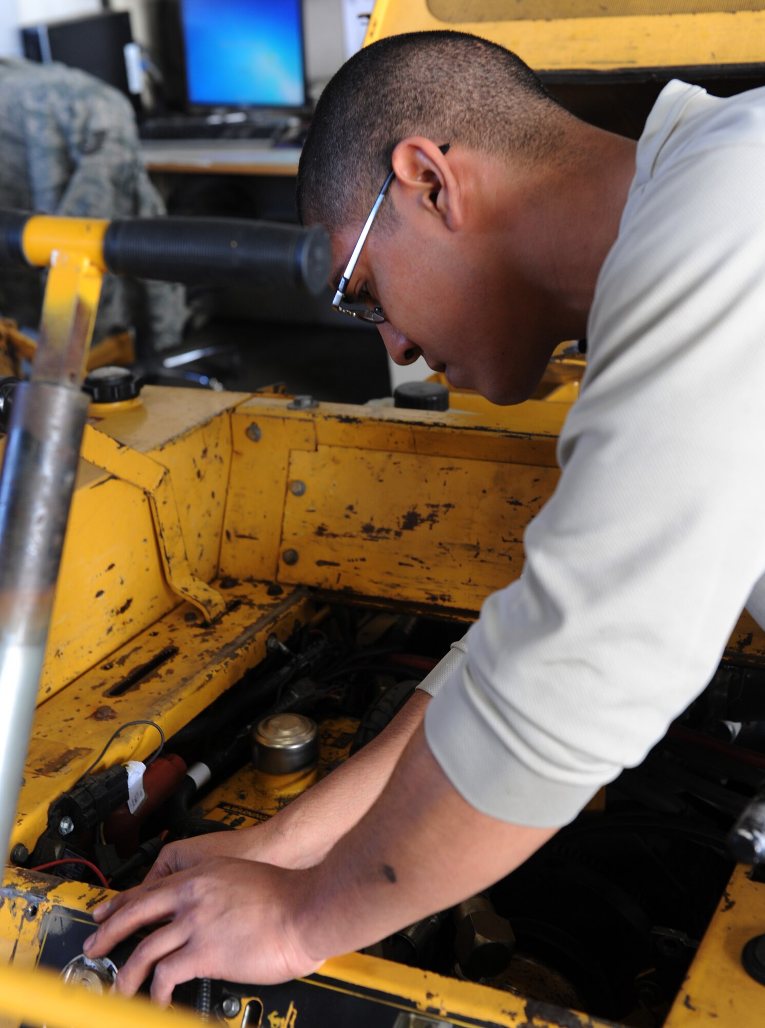 WHITEMAN AIR FORCE BASE, Mo. -- Airman 1st Class Brandon Castaneda, 509th Logistics Readiness Squadron vehicle mechanic, replaces a hydraulic hose on a lawnmower, Nov. 2. The vehicle maintenance shop works on about 45 different types of vehicles from large fire trucks, refuelers, and snow removal vehicles, to forklifts and lawn mowers. (U.S. Air Force photo/Airman 1st Class Bryan Crane) (Released)