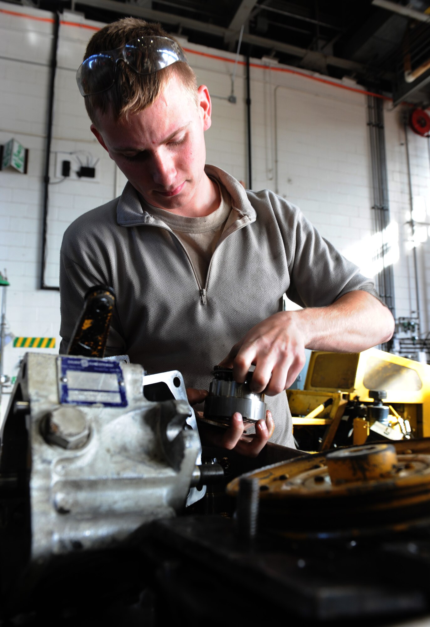 WHITEMAN AIR FORCE BASE, Mo. -- Airman 1st Class Jonathan Garland, 509th Logistics Readiness Squadron vehicle mechanic, rebuilds a hydraulic pump, Nov. 2.  The vehicle maintenance shop has approximately 70 airmen and civilian mechanics. (U.S. Air Force photo/Airman 1st Class Bryan Crane) (Released)