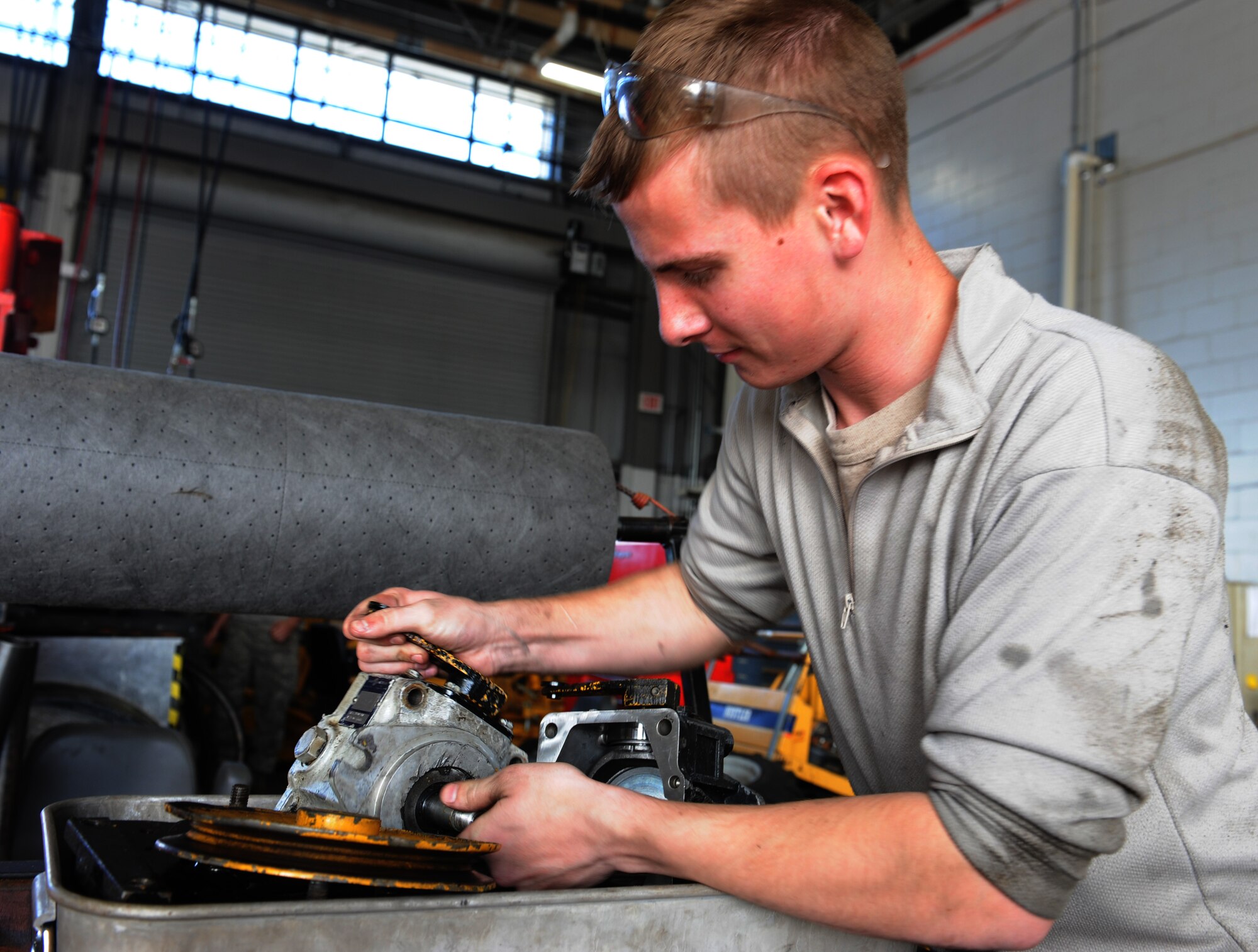 WHITEMAN AIR FORCE BASE, Mo. -- Airman 1st Class Jonathan Garland, 509th Logistics Readiness Squadron vehicle mechanic, rebuilds a hydraulic pump, Nov. 2 at Whiteman Air Force Base, Mo. The vehicle maintenance shop has approximately 70 airmen and civilian mechanics. (U.S. Air Force photo/Airman 1st Class Bryan Crane)(Released)