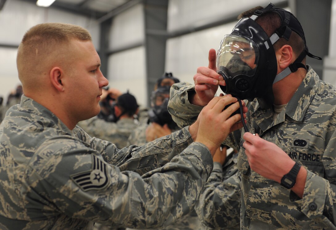 WHITEMAN AIR FORCE BASE, Mo. -- Staff Sgt. Cody Foreman, 509th Civil Engineer Squadron Chemical, Biological, Radiological and Nuclear instructor, helps Senior Airman Nathan Carns, 509th Maintenance Squadron low observable technician, fit his M-50 chemical mask during a CBRN training, Nov. 13. The M-50 chemical masked began replacing the MCU-2A/P chemical mask in 2009. (U.S. Air Force photo/Airman 1st Class Bryan Crane) (Released)