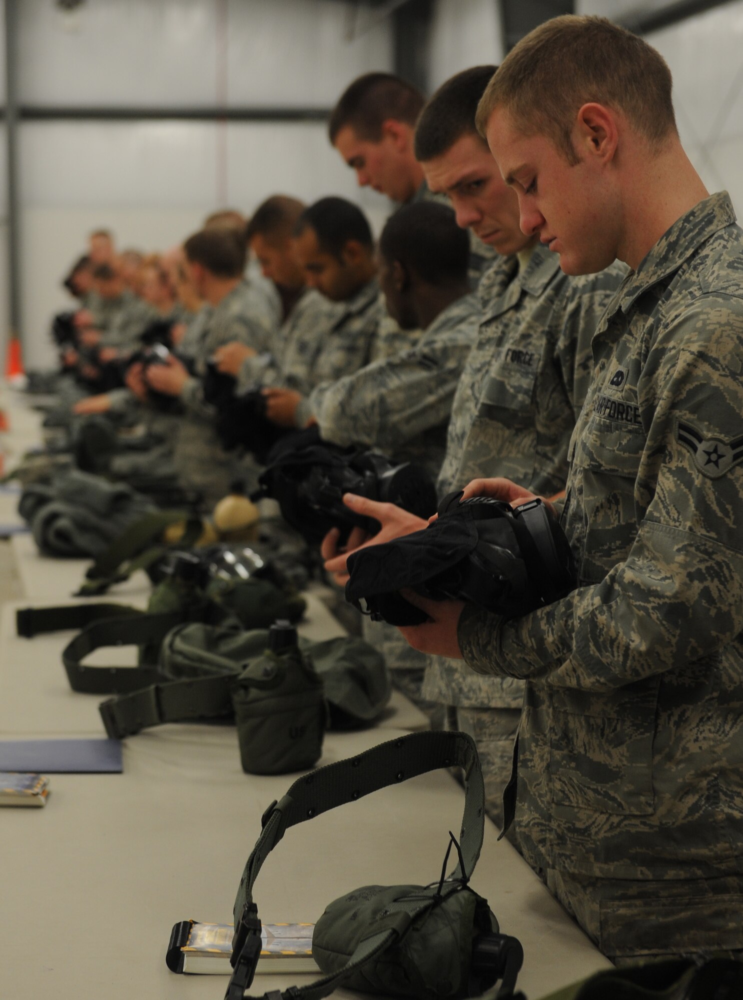 WHITEMAN AIR FORCE BASE, Mo. -- Airmen inspect their M-50 chemical masks for discrepancies during a Chemical, Biological, Radiological and Nuclear training session, Nov. 13. Chemical warfare training teaches Airmen how to survive and operate in hazardous environments whether deployed or at home. (U.S. Air Force photo/Airman 1st Class Bryan Crane) (Released)