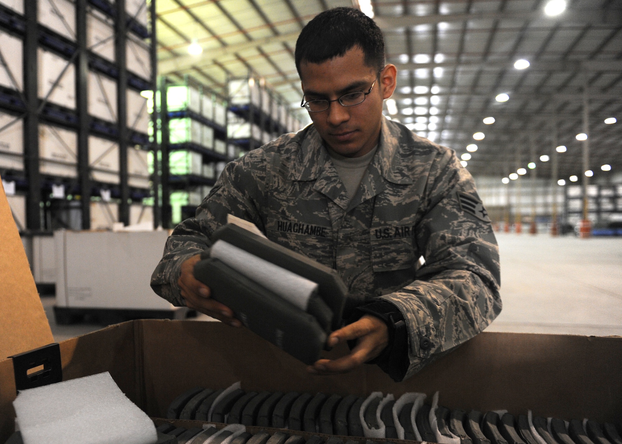 SOUTHWEST ASIA –Senior Airman Rey Huachambe, 379th Expeditionary Logistics Readiness Squadron individual protective equipment journeyman, boxes up ballistic armor plates to be redistributed across the area of responsibility Nov. 20, 2012. Huachambe was recognized during the Multi-Major Command Staff Assistance Visit for his ability to accurately account for more than 2,000 plates and keep 100-percent accountability as they were distributed across the AOR. Huachambe, a native of Richland, Wash., is deployed from 5th Logistics Readiness Squadron at Minot Air Force Base, N.D. (U.S. Air Force photo/Senior Airman Joel Mease)