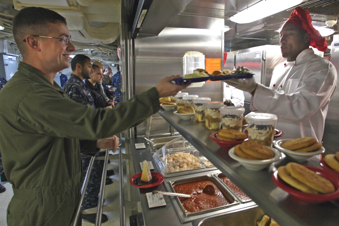 U.S. Marine Corps Staff Sgt. Walter Duncan, left, receives a