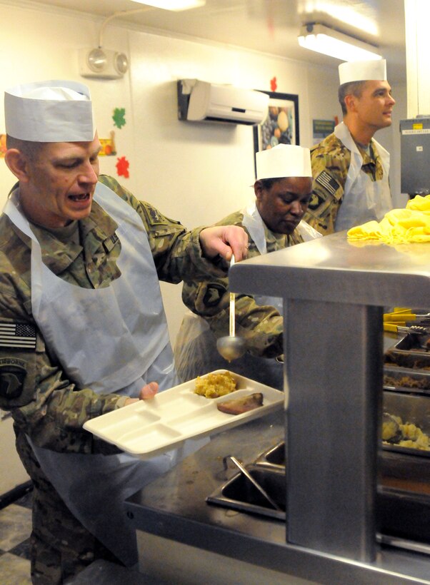 U.S. Army Chaplain (Maj.) William Graham, left, Master Sgt. Donna Clarke, center, and Lt. Col. Salome Herrera serve a Thanksgiving meal to service members on Bagram Airfiield, Afghanistan, Nov. 22, 2012.