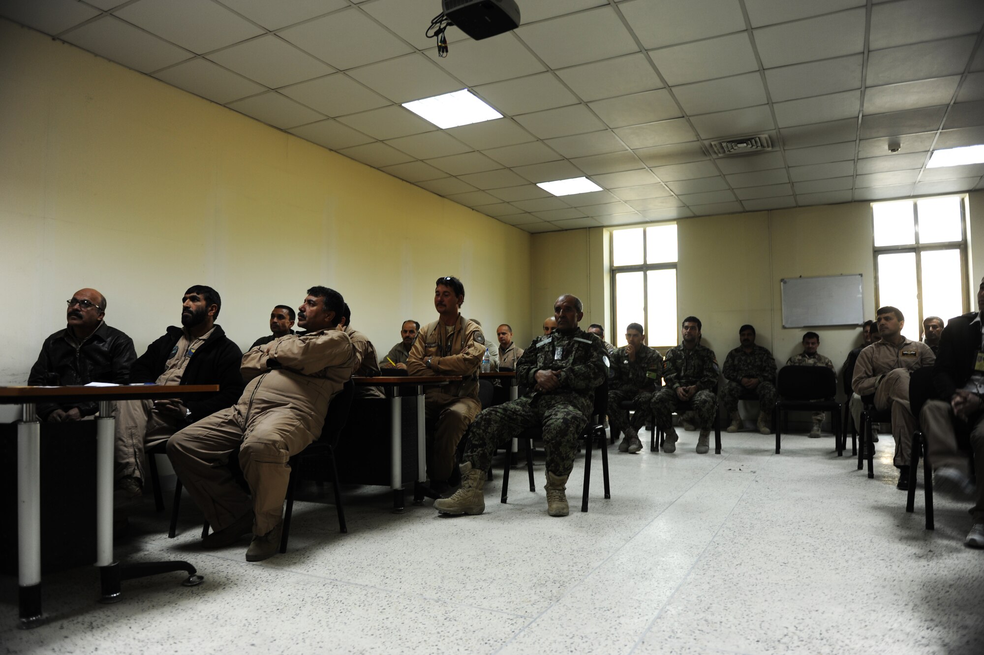Afghan Air Force, Coalition and U.S. Air Force aircrew listen as AAF Maj. Hamidullah, Kabul Air Wing section commander, briefs the daily report Nov. 15, 2012 at the Kabul, Afghanistan, International Airport. Every morning the weather is briefed to the aircrews to they can prepared to fly for the day.(U.S. Air Force photo/Staff Sgt. Melissa K. Mekpongsatorn)