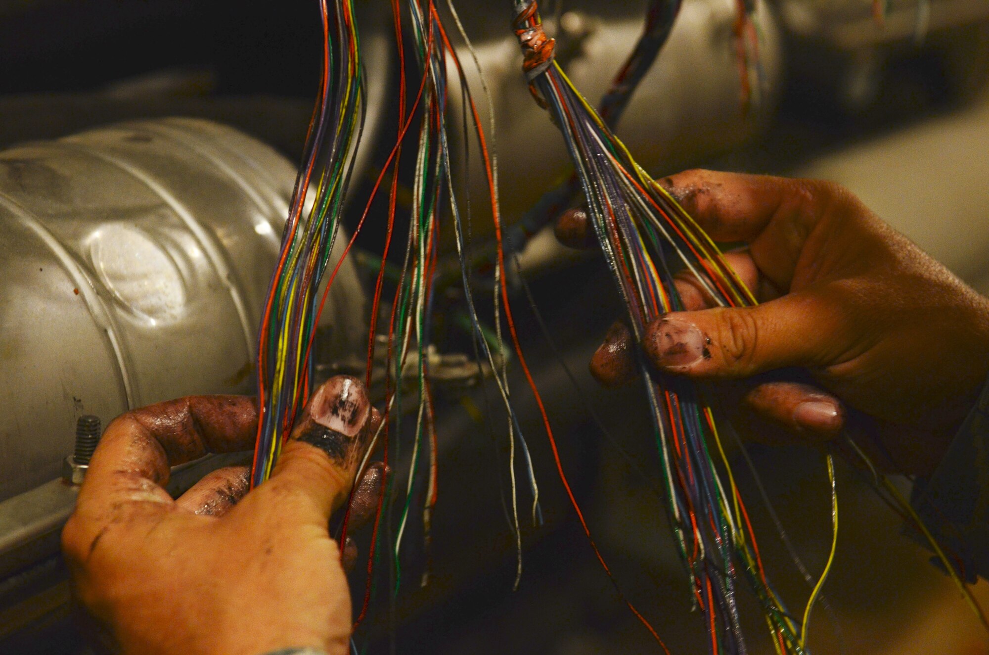 ANDERSEN AIR FORCE BASE, Guam—Telephone wires are separated by a member of the 36th Communications Squadron cable and antenna maintenance shop during routine maintenance here, Nov. 19.  (U.S. Air Force photo by Senior Airman Benjamin Wiseman/Released)