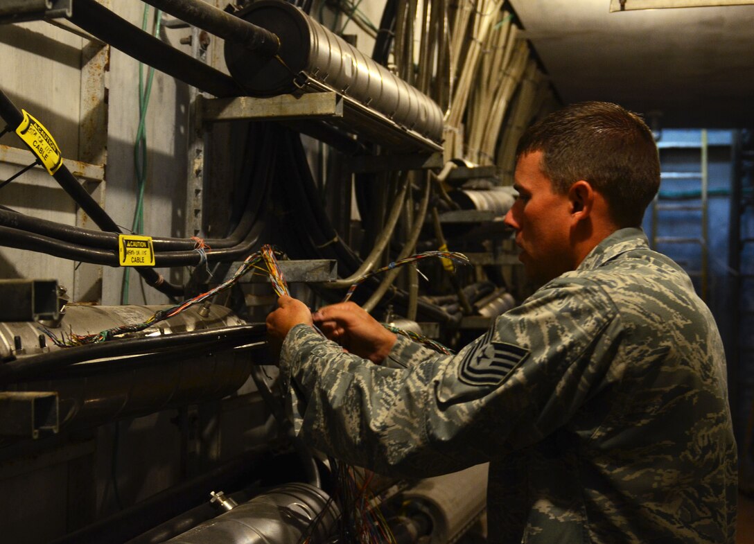 ANDERSEN AIR FORCE BASE, Guam— Tech. Sgt. Ryan Trandell, 36th Communications Squadron cable and antenna maintenance shop “Cable Dawgs” technician, works on telephone wire inside the cable vault here, Nov. 19. The Cable Dawgs are responsible for maintaining more than 33,000 feet of copper lines and 97 fiber-optic cables on Andersen. (U.S. Air Force photo by Senior Airman Benjamin Wiseman/Released)