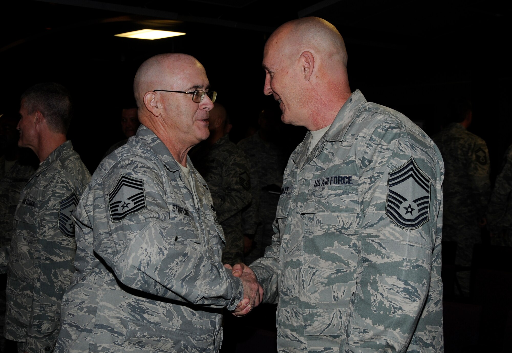 Chief Master Sgt. Hank Stripling, left, congratulates Chief Master Sgt. Stephen R. Bradley, who was named the 188th’s new command chief master sergeant during a unit training assembly Nov. 4 at the Colonel Hugh B. Correll Headquarters Facility. (National Guard photo by Senior Airman Hannah Landeros/188th Fighter Wing Public Affairs)