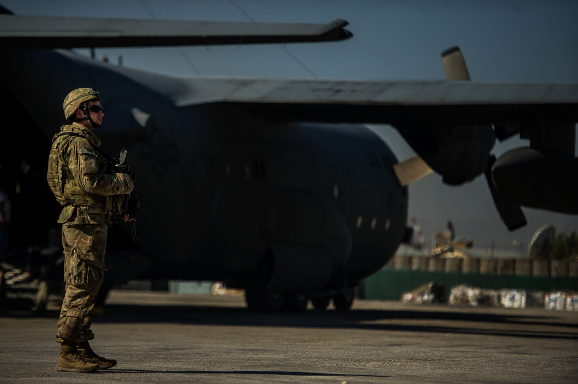 U.S. Air Force Senior Airman David Lee, 455th Expeditionary Security Forces Squadron, secures the perimeter around a U.S. Air Force C-130H Hercules Nov. 3, 2012, at a forward operating base in Afghanistan. When an aircraft lands at locations with little to no security on the landing strip, fly-away security teams come along to provide additional protection for the aircraft and crew. Lee's hometown is Mesa, Ariz. (U.S. Air Force photo/Staff Sgt. Jonathan Snyder)
