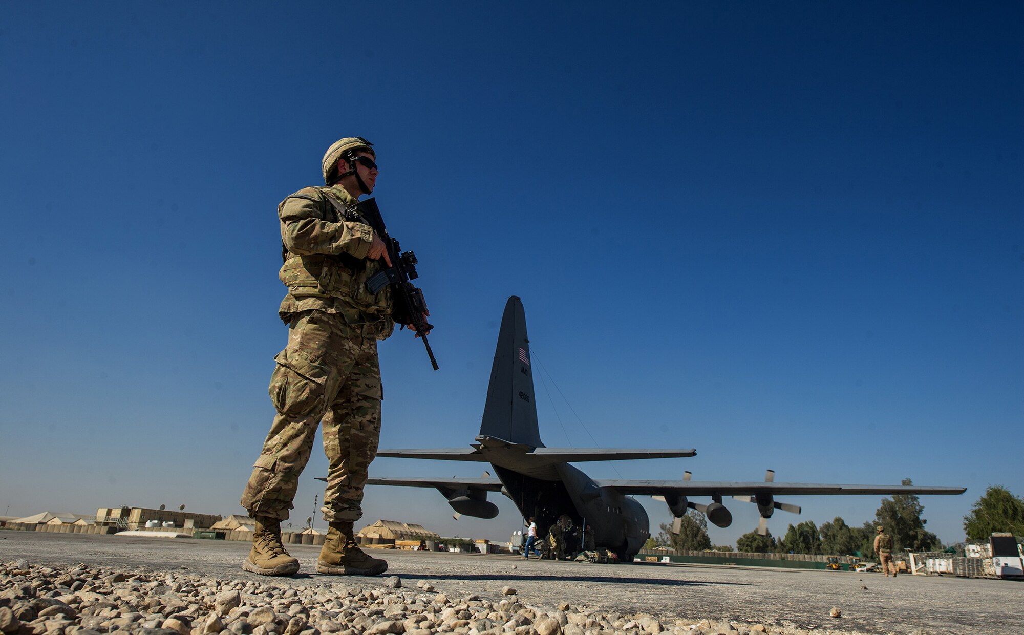 U.S. Air Force Senior Airman David Lee, 455th Expeditionary Security Forces Squadron, secures the perimeter around a U.S. Air Force C-130H Hercules Nov. 3, 2012, at a forward operating base in Afghanistan. When an aircraft lands at locations with little to no security on the landing strip, fly-away security teams come along to provide additional protection for the aircraft and crew. Lee's hometown is Mesa, Ariz. (U.S. Air Force photo/Staff Sgt. Jonathan Snyder)