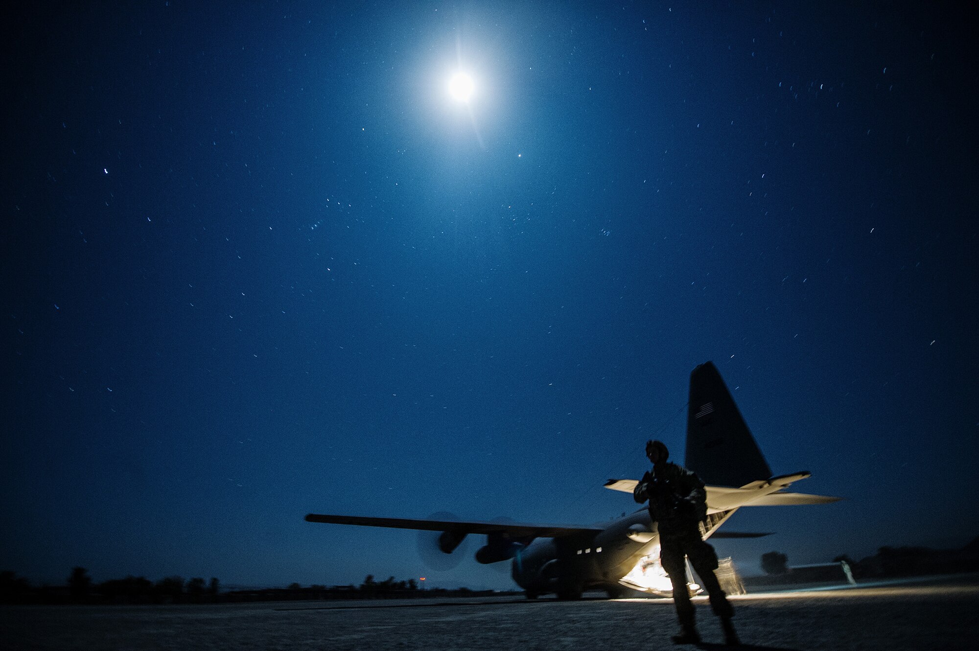 U.S. Air Force Senior Airman David Lee, 455th Expeditionary Security Forces Squadron, secures the perimeter around a U.S. Air Force C-130H Hercules Nov. 3, 2012, at a forward operating base in Afghanistan. When an aircraft lands at locations with little to no security on the landing strip, fly-away security teams come along to provide additional protection for the aircraft and crew. Lee's hometown is Mesa, Ariz. (U.S. Air Force photo/Staff Sgt. Jonathan Snyder)
