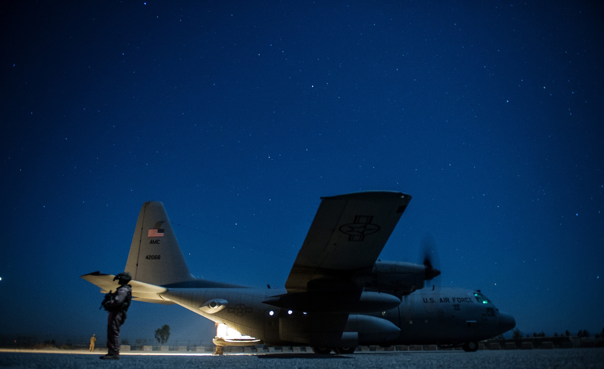 U.S. Air Force Senior Airman William Stewart, 455th Expeditionary Security Forces Squadron, secures the perimeter around a U.S. Air Force C-130H Hercules Nov. 3, 2012, at a forward operating base in Afghanistan. When an aircraft lands at locations with little to no security on the landing strip, fly-away security teams come along to provide additional protection for the aircraft and crew. Stewart's hometown is Franklin, Ky. (U.S. Air Force photo/Staff Sgt. Jonathan Snyder)