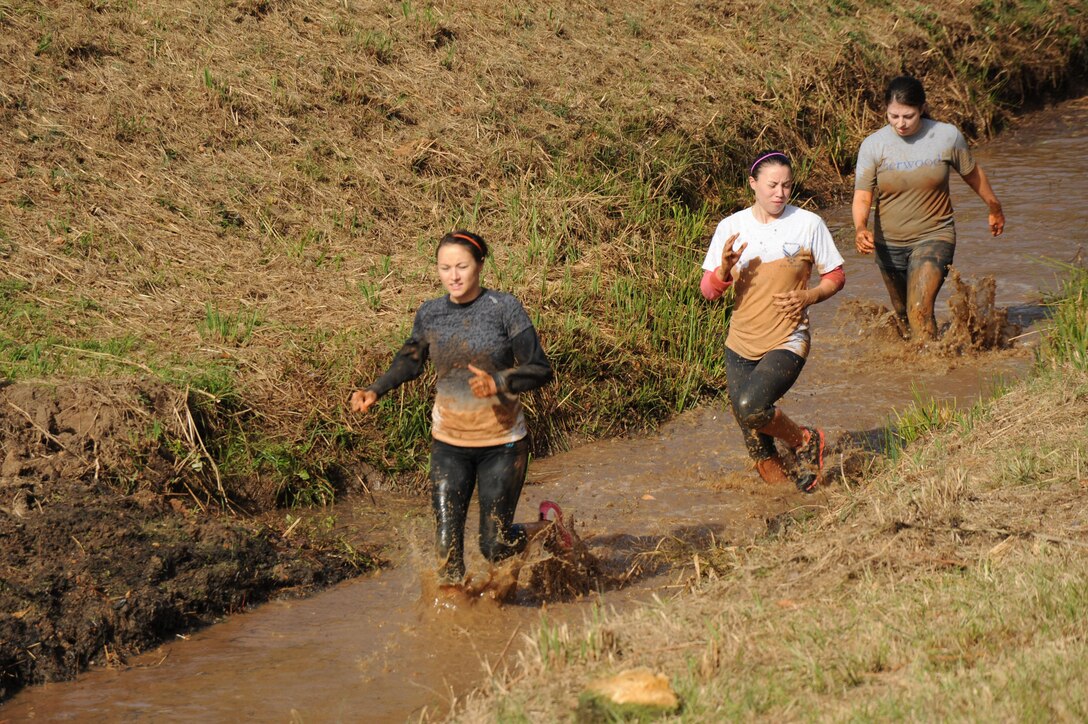Runners slog through the mud in a canal during Marine Corps Logistics Base Albany's Dirty Devil Dog Mud Run, Nov. 17.