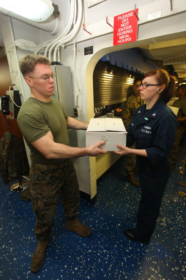 Lance Cpl. Nicholas Jenkins, left, an Appamattox, Va., native with Weapons Company, Battalion Landing Team 1st Battalion, 2nd Marine Regiment, 24th Marine Expeditionary Unit, works with a sailor to store boxes of food during a replenishment at sea detail, or RAS, aboard the USS Iwo Jima Nov. 24, 2012. During the RAS the USS Iwo Jima took on fuel, fresh fruits, vegetables, and supplies to sustain the ship while underway. The 24th Marine Expeditionary Unit is deployed with the Iwo Jima Amphibious Ready Group in the 6th Fleet area of responsibility serving as an expeditionary crisis response force capable of a variety of missions, from full-scale combat to evacuations and humanitarian assistance. Since deploying in March, they have supported a variety of missions in the U.S. Central, Africa and European Commands, assisted the Navy in safeguarding sea lanes, and conducted various bilateral and unilateral training events in several countries in the Middle East and Africa. (U.S. Marine Corps photo by Lance Cpl. Tucker S. Wolf/Released) 