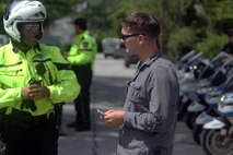 A Marine receives instruction from a Jacksonville Police Officer before participating in the practical exercise of "BikeSafe" -- a program designed to improve the skills of motorcyclists by observing the rider while operating a motorcycle.