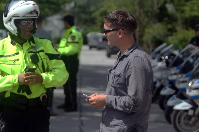A Marine receives instruction from a Jacksonville Police Officer before participating in the practical exercise of "BikeSafe" -- a program designed to improve the skills of motorcyclists by observing the rider while operating a motorcycle.