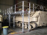 A rollable system of platforms, walls, and ladders was designed to prevent falls while working on amphibious assualt vehicals at MCSF Blount Island.