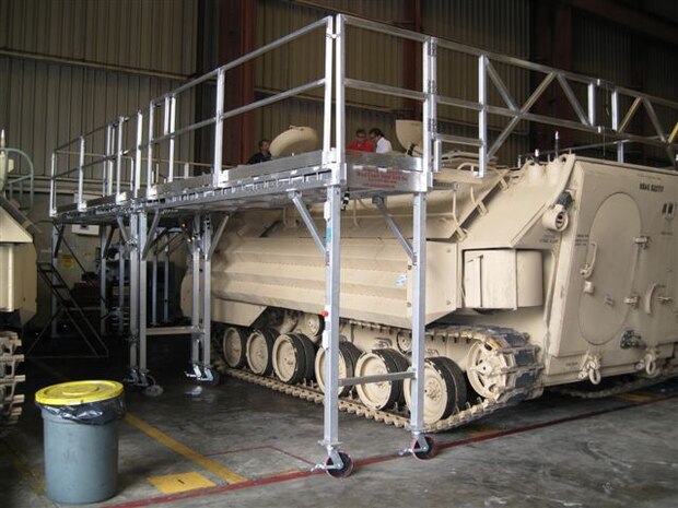 A rollable system of platforms, walls, and ladders was designed to prevent falls while working on amphibious assualt vehicals at MCSF Blount Island.