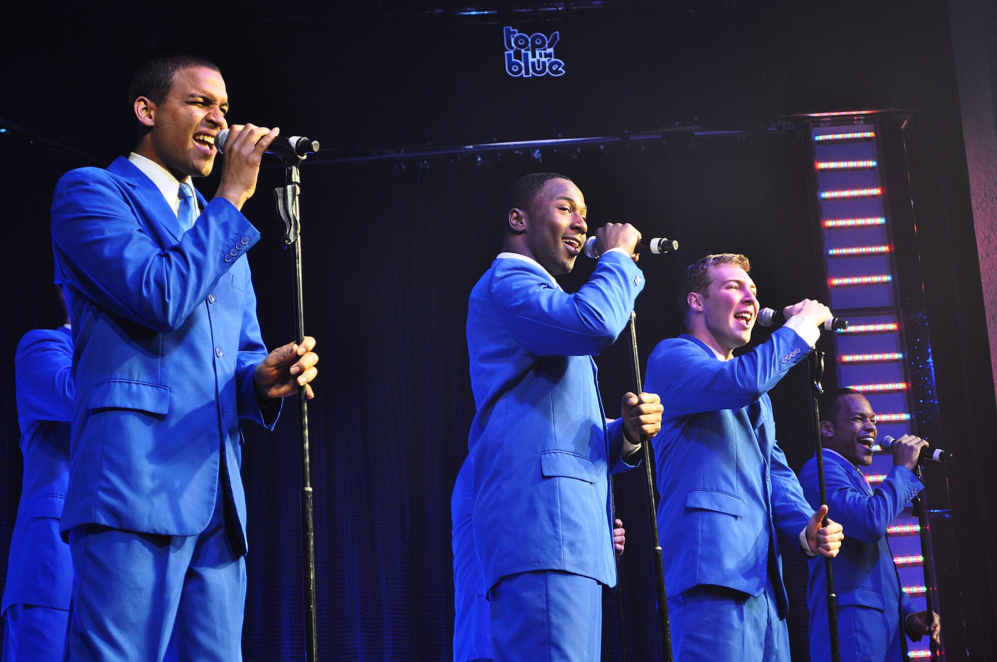 Senior Airman Emmanuel Maldonado Rosario, 81st Dental Squadron dental assistant journeyman;  Keesler Air Force Base, Miss.; takes the lead on an all male medley during the Tops in Blue show Nov.24, 2012 at Osan Air Base Theater. Their show, titled “Listen,” featured a wide range of dynamic rhythms to include Earth, Wind & Fire, Maroon 5, Whitney Houston, and Lady Antebellum. (U.S. Air Force photo/Senior Airman Kristina Overton)