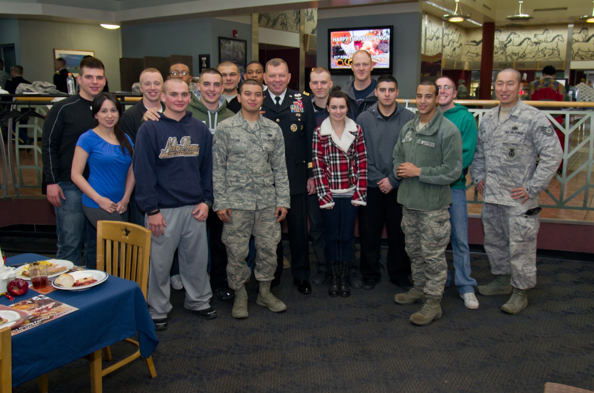 Osan Airmen pose with Gen. James Thurman, U.S. Forces Korea commander, after eating Thanksgiving dinner at the Ginko Tree dining facility, Nov. 22, 2012. Thurman visited United States Forces Korea service members at Camp Hovey, Osan Air Base and Camp Mujuk. (U.S. Army photo/Sgt. Brian Gibbons)