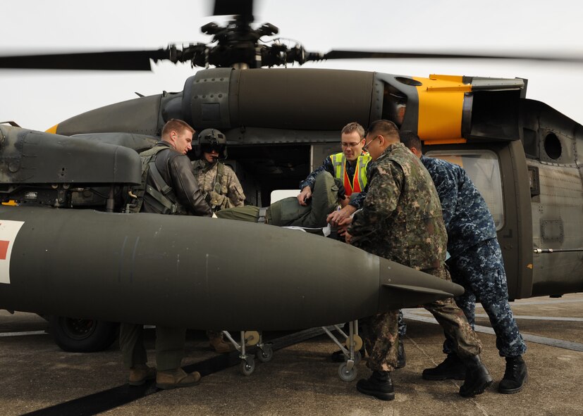 Airmen from Kunsan Air Base, Republic of Korea, US and ROK Sailors out of Chinhae Naval Station, ROK, and  Soldiers fromCamp Humphreys, ROK, unload a patient from a UH-60Q Black Hawk during a training exercise on Chinhae Naval Station, ROK, Nov. 21, 2012. This was part of a medical evacuation training scenario which tested the capabilities of the numerous personnel involved. (U.S. Air Force photo/Staff Sgt. Jonathan Fowler)