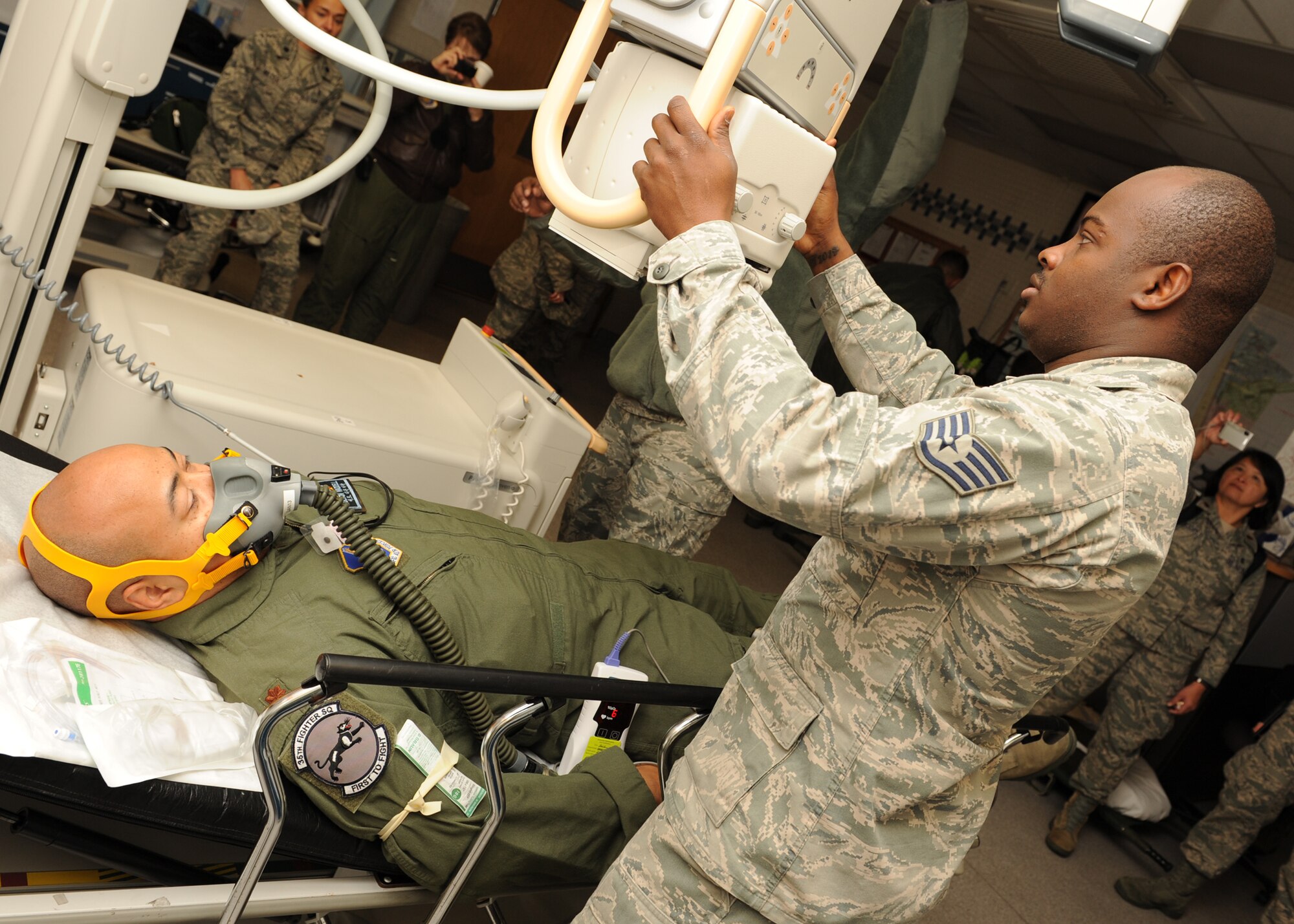 Staff Sgt. Mohamed Swarray, 8th Medical Support Squadron, prepares to X-ray Maj. Franklin Waddell, 8th Medical Operations Squadron, during a training exercise on Kunsan Air Base, Republic of Korea, Nov. 21, 2012. This was part of a joint medical evacuation exercise that included US Air Force, US Army, US Navy and ROK Navy personnel. (U.S. Air Force photo/Staff Sgt. Jonathan Fowler)