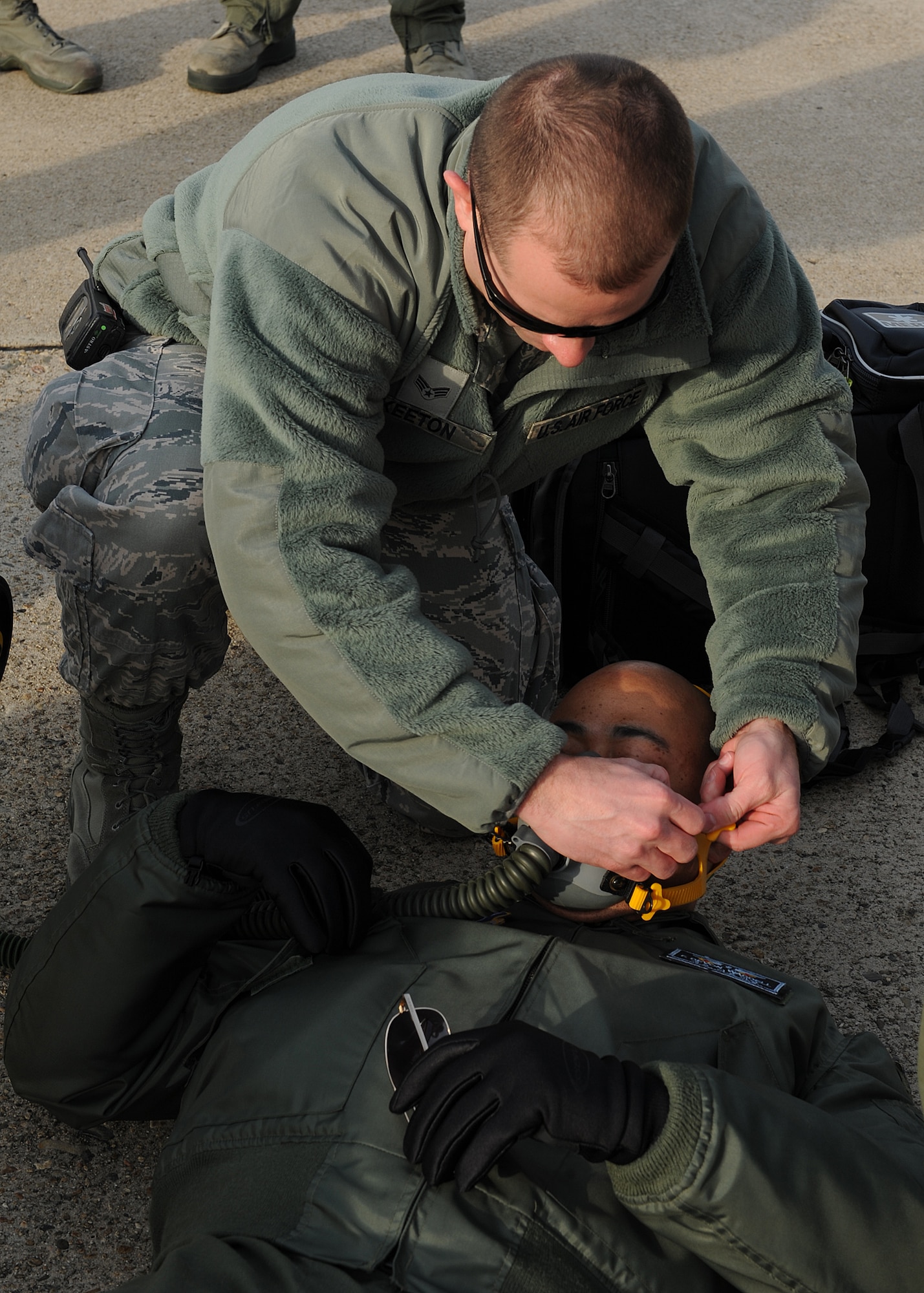 Senior Airman Christopher Keeton, 8th Medical Operations Squadron, secures a mask to Maj. Franklin Waddell, 8th MDOS, during a training exercise on Kunsan Air Base, Republic of Korea, Nov. 21, 2012. This was part of a medical evacuation exercise which tests the medical evacuations procedures of the 8th MDOS. (U.S. Air Force photo/Staff Sgt. Jonathan Fowler)