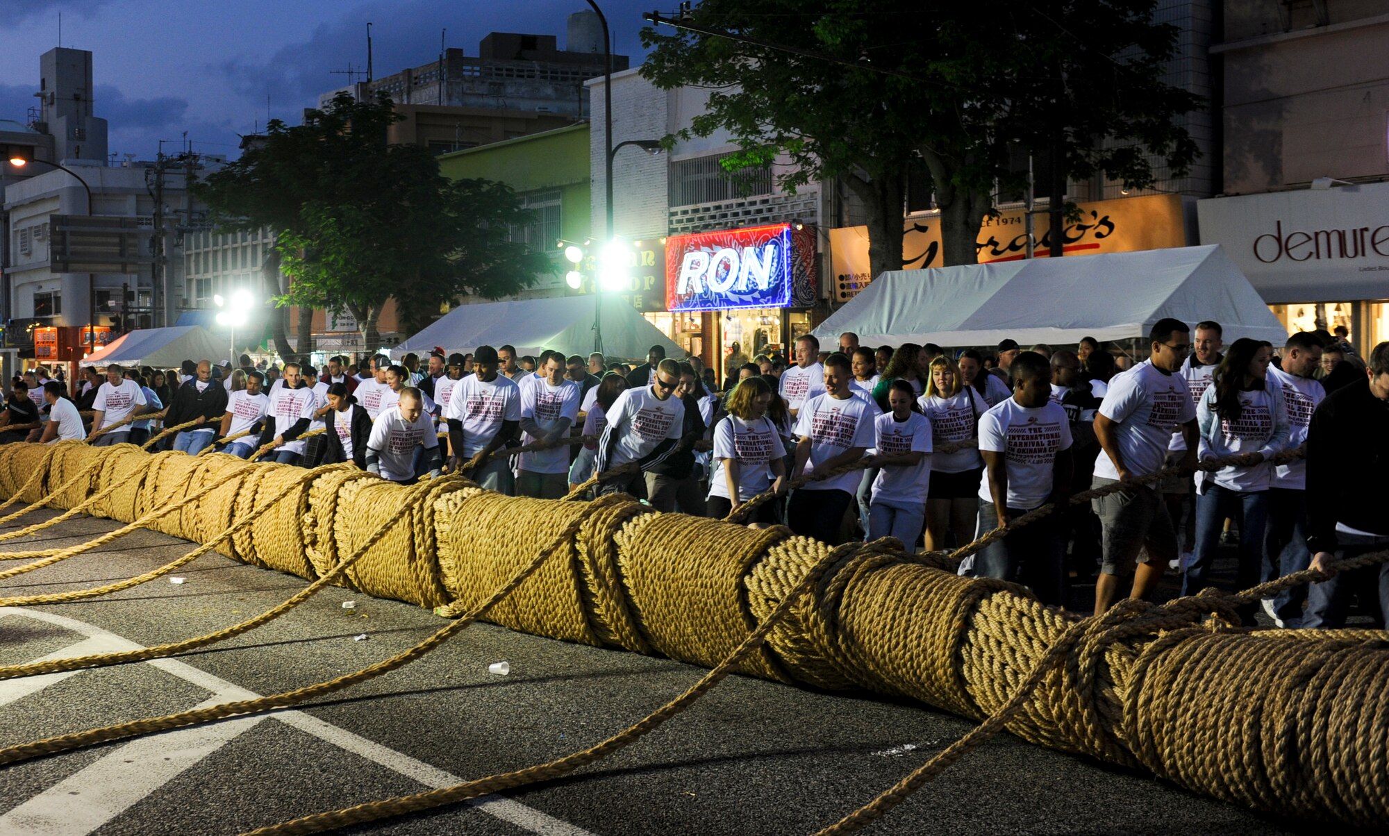 Airman Committed to Excellence and other volunteers help move the tug-of-war rope in Okinawa, Japan, Nov. 24, 2012. This is the 21st carnival that aimed to include various activities with the base and local community. It also promotes international friendships across diverse cultures through a variety of music, sports and stage events. (U.S. Air Force photo/Airman 1st Class Justin Veazie)
