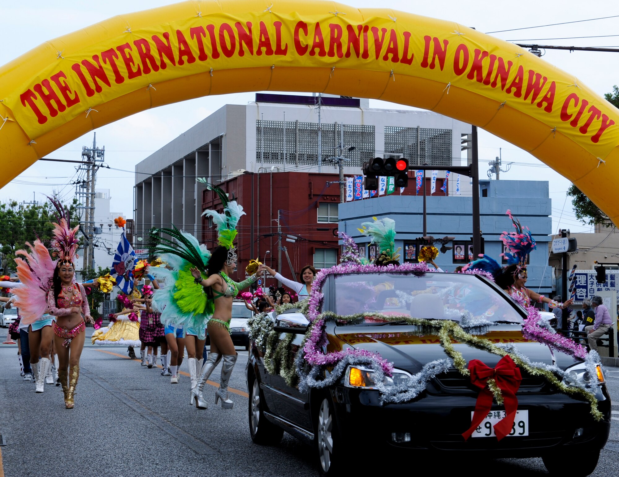 During the International Carnival participants in the International Parade entertain spectators at Gate 2 in Okinawa, Japan, Nov. 24, 2012. Approximately 900 locals, service members and family members participated in the International Parade including more than 100 volunteers from Kadena High School's marching band, Ballet Folklorico Mexicano de Okinawa, Order of Eastern Star, and individuals from U.S. military bases across Okinawa.  (U.S. Air Force photo/Airman 1st Class Justin Veazie)