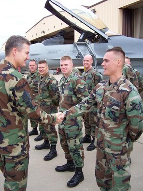Then Staff Sgt. Robby Gallegos (right) shakes hands with former Chief Master Sgt. of the Air Force Gerald Murray during an official CMSAF visit.  Gallegos finished his Community College of the Air Force degree, bachelors degree and is now about to finish his masters degree, while now serving as a captain in the U.S. Air Force.  (Courtesy photo)