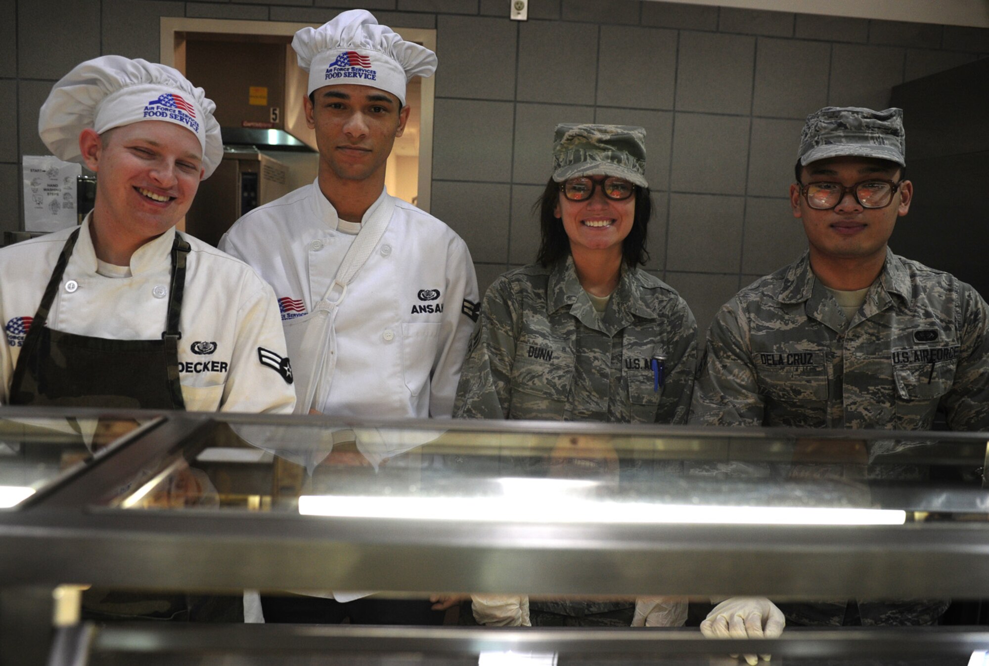 The Pecos Trail Dining Facility staff smiles as they serve the Thanksgiving meal at Cannon Air Force Base, N.M., Nov. 22, 2012. The dining facility staff went to great lengths to provide a filling and heartwarming experience for the Airmen who were unable to be with their families during the holiday. (U.S. Air Force photo/Airman 1st Class Ericka Engblom)

