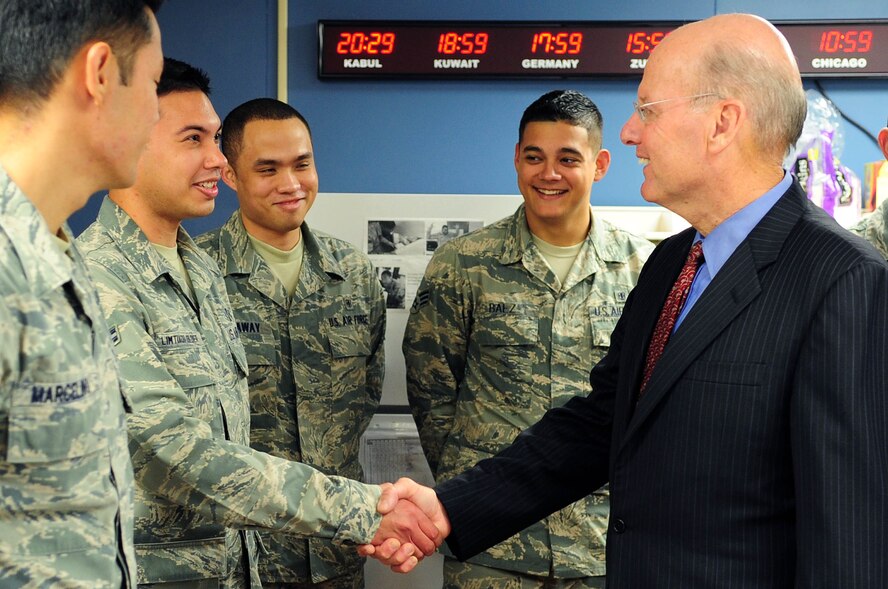 U.S. Navy Vice Admiral (ret.) Norb Ryan, Military Officers Association of America president, greets Airman 1st Class James Limtiaco-Soldier, 779th Medical Group Aeromedical Staging Facility medical technician, during a visit to the ASF, Oct. 16, at Joint Base Andrews, Md. The 779th MDG ASF team members were awarded the MOAA 2012 Community Heroes Award in the Military Caregivers category recently for their endless dedication to helping wounded warriors returning from overseas everyday at JBA. (U.S. Air Force photo by Senior Airman Steele C. G. Britton)