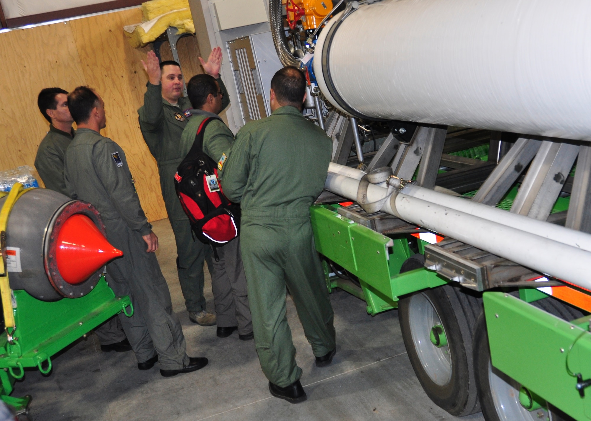 With his hands in the air, 302nd Airlift Wing Modular Airborne Fire Fighting System qualified C-130 loadmaster Master Sgt. Jason Harvey explains the upload procedure of the U.S. Forest Service MAFFS II unit to the visiting MAFFS C-130 aircrew from the Brazilian Air Force.  Four MAFFS C-130 aircrew members of the Brazilian Air Force’s 1st Group Troop Transport visited the Air Force Reserve Command’s 302nd AW at Peterson Air Force Base, Colo., Nov. 15, 2012 to learn more about the 302nd AW’s MAFFS program and more specifically, the Air Force Reserve unit’s conversion from the MAFFS legacy system to the MAFFS II system.  The five-day visit included classroom instruction, open dialogue between the two countries’ MAFFS subject matter experts and hands-on tours of the U.S. Forest Service MAFFS II units. The Brazilian Air Force plans to transition to the MAFFS II system in the near future. (U.S. Air Force photo/Ann Skarban)