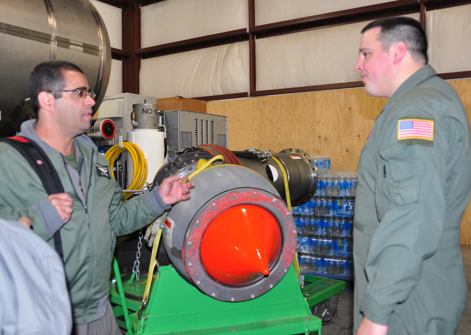 Brazilian Air Force C-130 loadmaster, Master Sgt. Rodrigo Pardini (left) asks Master Sgt. Jason Harvey, 302nd Airlift Wing MAFFS-qualified C-130 loadmaster questions about delivery coverage levels the Modular Airborne Fire Fighting System II nozzle can deliver. Pardini and three members of the Brazilian Air Force’s 1st Group Troop Transport visited the Air Force Reserve Command’s 302nd AW at Peterson Air Force Base, Colo., Nov. 15, 2012 to learn more about the 302nd AW’s MAFFS program and more specifically, the Air Force Reserve unit’s conversion from the MAFFS legacy system to the MAFFS II system.  The five-day visit included classroom instruction, open dialogue between the two countries’ MAFFS subject matter experts and hands-on tours of the U.S. Forest Service MAFFS II units. The Brazilian Air Force plans to transition to the MAFFS II system in the near future. (U.S. Air Force photo/Ann Skarban)