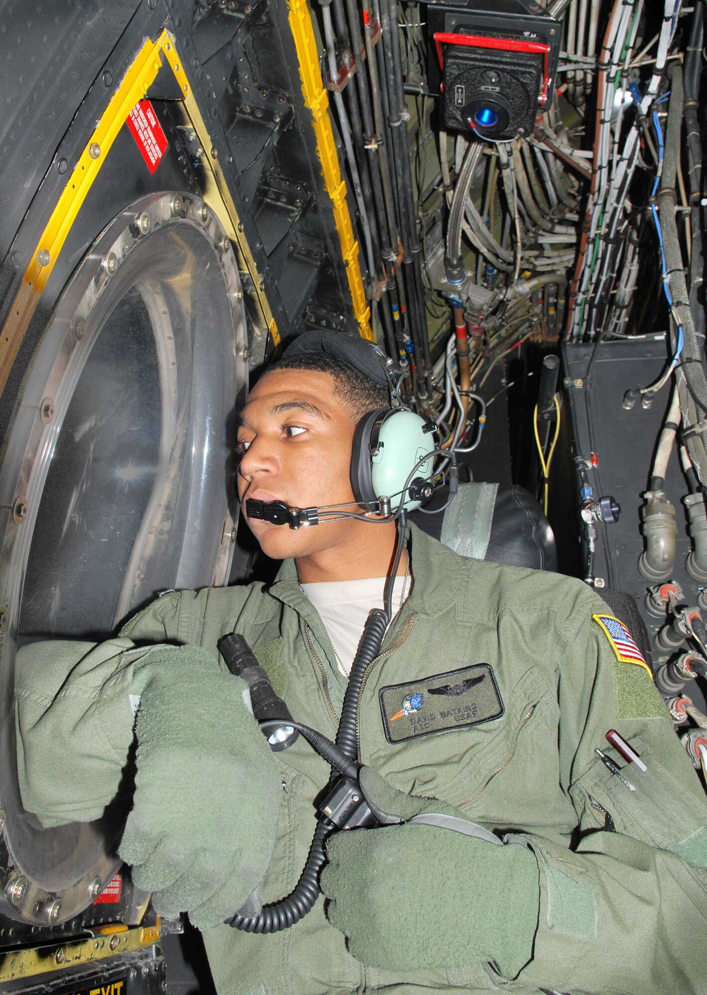 U.S. Air Force Airman 1st Class David Watkins, 16th Special Operations Squadron, gazes out the window of an AC-130H Spectre gunship after helping the rest of the crew prepare for a successful mission at Cannon Air Force Base, N.M., Nov. 8, 2012. The flight was part of a routine training mission conducted over White Sands Missile Range, N.M., in coordination with coalition forces both on the ground and in the air.(U.S. Air Force photo/Desiree Ann Montenegro) 