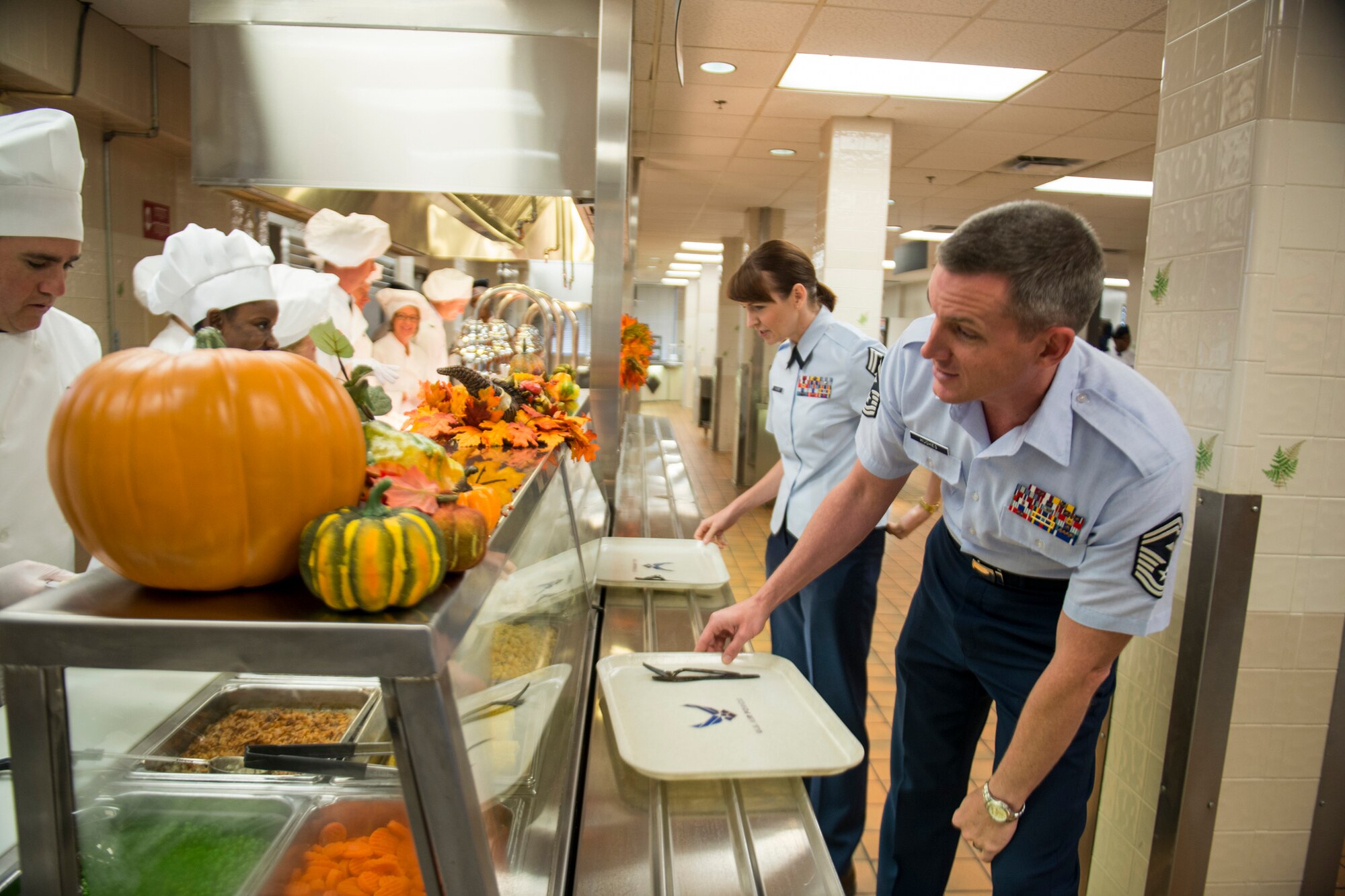U.S. Senior Master Sgts. Derek and Heather Hughes look over a selection of food during Thanksgiving at the Georgia Pines Dining Facility, Moody Air Force Base, Ga., Nov. 22, 2012. The DFAC served Thanksgiving lunch and dinner, which were available to all members of the Moody community and their guests. (U.S. Air Force photo by Staff Sgt. Jamal D. Sutter/Released) 