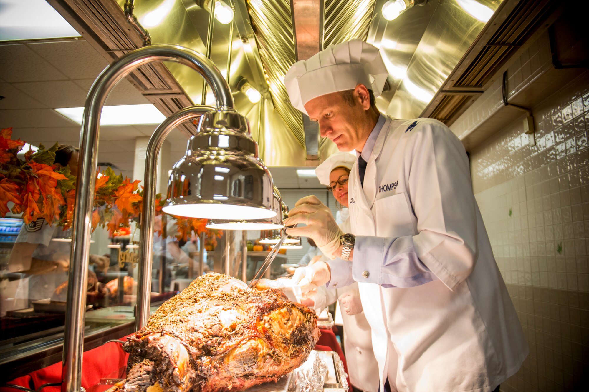 U.S. Air Force Col. Billy Thompson, 23d Wing commander, slices roast beef during Thanksgiving at the Georgia Pines Dining Facility, Moody Air Force Base, Ga., Nov. 22, 2012. Thompson and many other base leaders helped serve a customary Thanksgiving meal at the DFAC for Airmen and families. (U.S. Air Force photo by Staff Sgt. Jamal D. Sutter/Released)