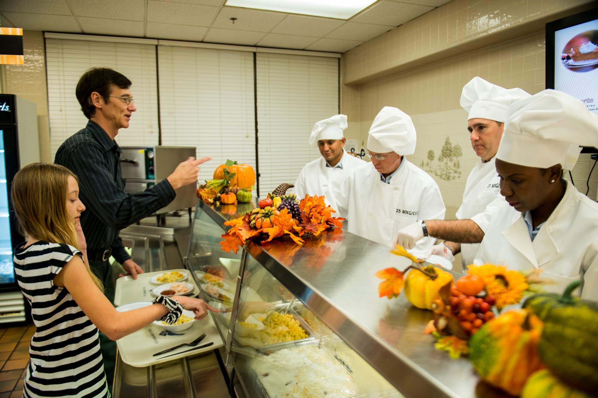 U.S. Air Force retired Tech. Sgt. Christian Lefebvre and his daughter, Caitlyn, choose their Thanksgiving meal selections at the Georgia Pines Dining Facility, Moody Air Force Base, Ga., Nov. 22, 2012. The DFAC served lunch and dinner for those who did not have a place to eat for Thanksgiving or wanted to enjoy a meal without the having to prepare one of their own. (U.S. Air Force photo by Staff Sgt. Jamal D. Sutter/Released) 
