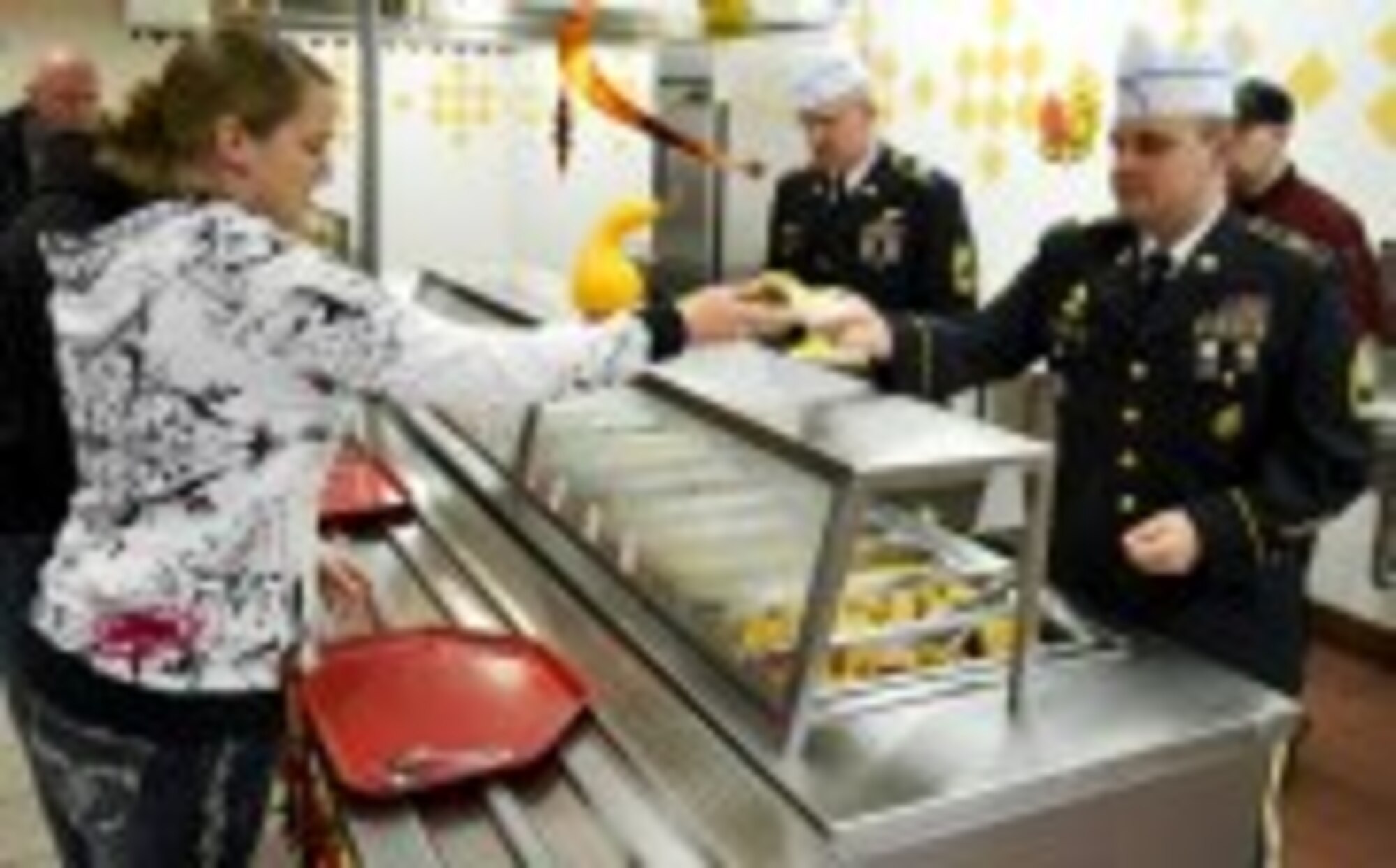 U.S. Army First Sgt. Steven Lopez, 7th Sustainment Brigade, serves food to soldiers, family, and friends gathered at the Fort Eustis, Va.  "Resolute Cafe" for a Thanksgiving feast, Nov. 22, 2012. Nearly 500 Soldiers attended the feast, that offered most of the traditional atmosphere and trimmings of a home cooked meal. (U.S. Army photo by Sgt. 1st Class Brian G. Rhodes/Released) 
