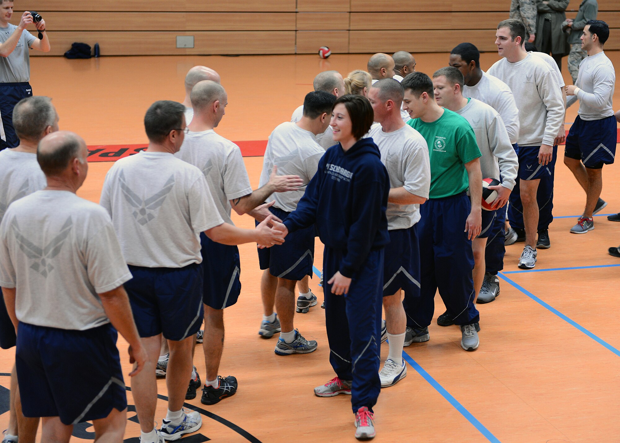 SPANGDAHLEM AIR BASE, Germany – U.S. Air Force Senior Airman Roz Roueche, 52nd Logistics Readiness Squadron, leads the Globemaster flight’s congratulatory handshake at the end of the first sergeant versus 52nd Force Support Squadron Airman Leadership School student volleyball game at the Skelton Memorial Fitness Center Nov. 21. The volleyball game is a tradition of the Pitsenbarger ALS where each class’ students learn teamwork and communication skills while battling the well-practiced first sergeants. The first sergeants continued their reign by winning 3-2 matches. (U.S. Air Force photo by Staff Sgt. Daryl Knee/Released)