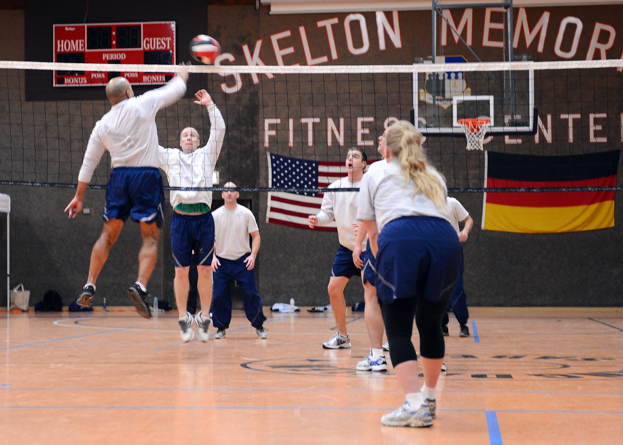 SPANGDAHLEM AIR BASE, Germany – U.S. Air Force Master Sgt. Jason Garo, 52nd Component Maintenance Squadron first sergeant, spikes a volleyball toward unsuspecting U.S. Air Force Senior Airman Todd Hughes, 52nd Equipment Maintenance Squadron, during the first sergeant versus 52nd Force Support Squadron Airman Leadership School student volleyball game at the Skelton Memorial Fitness Center Nov. 21. The shirt team continued their reign by defeating the ALS all-star team with an overall match score of 3-2. (U.S. Air Force photo by Staff Sgt. Daryl Knee/Released)